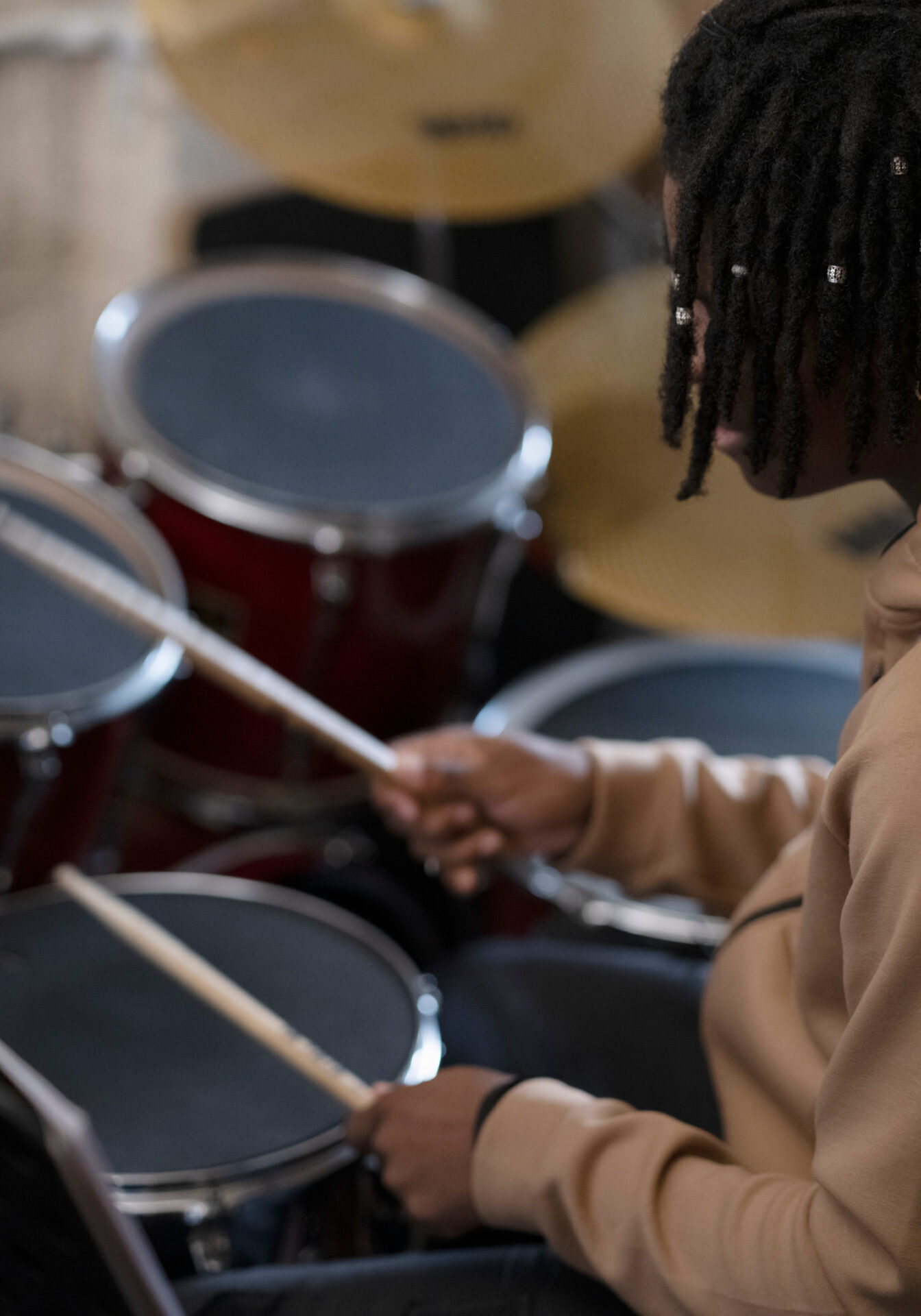 Teenage boy practicing playing drums